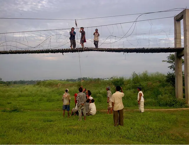 A suspension bridge being built over the Dhansiri river